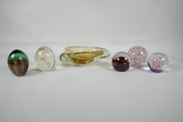 A quantity of art glass paperweights, including one signed Langham, and a Murano amber glass dish,