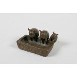 A Japenese Jizai style bronze of three pigs at a trough, impressed seal mark to base, 1½" wide