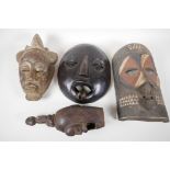 Three African carved wood tribal masks and a carved wood ceremonial bell, largest 13½" long