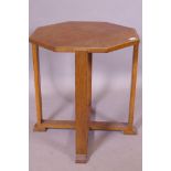 An early C20th Arts & Crafts octagonal top oak occasional table, raised on four square supports