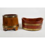 A coopered wood and brass bound barrel shaped planter, and another of oval form, largest 6½" high