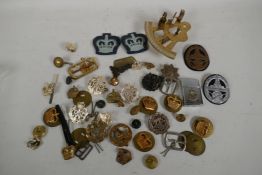 A collection of militaria including two German WWII cap badges, and RAF Zenith lighter badges,