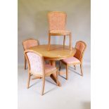 A mid century Parker Knoll teak extending dining table with lazy Susan and four chairs ensuite,