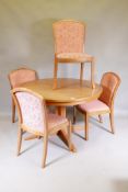 A mid century Parker Knoll teak extending dining table with lazy Susan and four chairs ensuite,