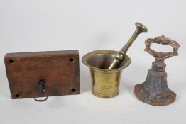 An antique iron lock, with key,  a C19th brass mortar and pestle, and a cast iron door stop, 7½"