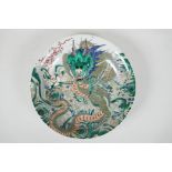 A famille vert enamelled porcelain charger, depicting a dragon chasing the flaming pearl, Chinese,