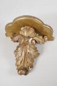 A C19th carved gilt wood wall bracket, carved as an acanthus leaf, 12" long x 13" wide x 7" deep