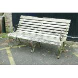 A wrought iron garden bench with wood slats, late C19th/early C20th, 60" wide