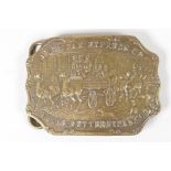 A vintage brass belt buckle, embossed with a horse drawn carriage advertising American Express H. E.