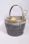 An antique coopered barrel log bin with brass handle and metal liner, 16" diameter x 11"