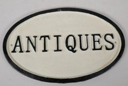 A cast iron "Antiques" sign, 13½ x 8½"