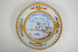 An C18th/C19th polychrome Delft charger decorated with a Dutch landscape, minor losses to glaze,