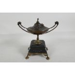 A C19th bronze urn and cover on a marble and ormolu stand, the cover cast with flowers and a bird,