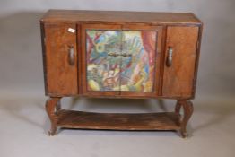 An Arts and Crafts oak side cabinet with painted central doors and undertier on cabriole supports,