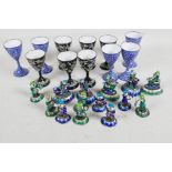 A quantity of oriental enamel figures, largest 2" high, and two sets of enamel goblets