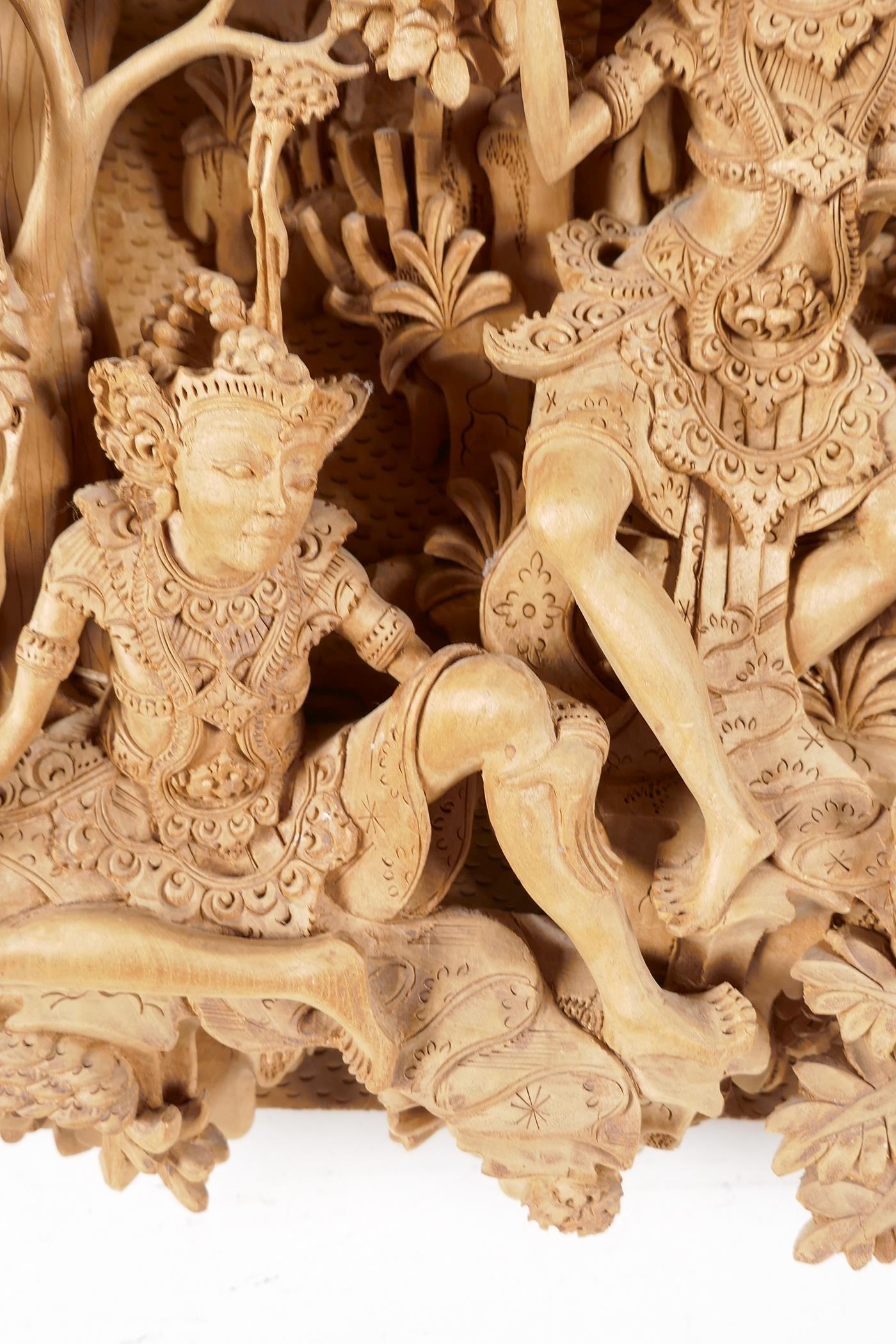 A Balinese carved sandlewood wall plaque, carved as two dancers resting under a tree, 16" x 9½" - Image 2 of 6