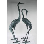 A pair of cast metal garden figures of cranes, largest 33½" high