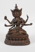 A Sino-Tibetan bronze of a many armed deity, seated on a lotus throne. Carrying auspicious items,