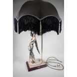 A contemporary table lamp in the Art Deco style, formed as a lady with peacock on her shoulder,