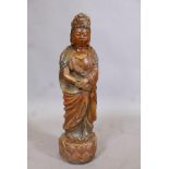 A carved softwood figure of Quan Yin with polychrome and parcel gilt decoration, 24" long