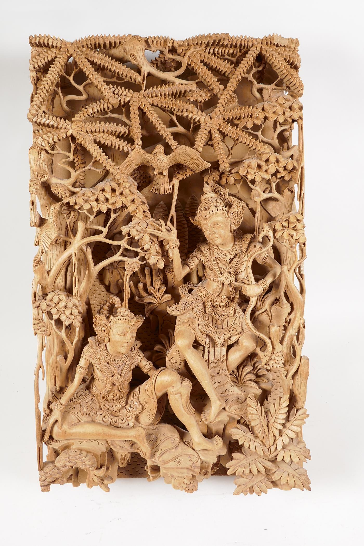 A Balinese carved sandlewood wall plaque, carved as two dancers resting under a tree, 16" x 9½" - Image 4 of 6