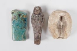 An Egyptian Faience pottery token in the form of Horus, together with a brown glazed Shabti and a