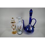 A gilt decorated blue glass wine ewer and stopper, 19" high, a milk glass vase painted with flowers,