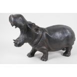 A cast metal figurine of a hippopotamus with mouth agape, 15" long