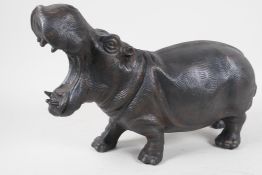 A cast metal figurine of a hippopotamus with mouth agape, 15" long