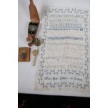 A quantity of vintage sewing ephemera including a tartanware tape measure and a stiched sampler by