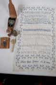A quantity of vintage sewing ephemera including a tartanware tape measure and a stiched sampler by