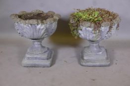 A pair of weathered concrete garden urns, 19" diameter