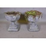 A pair of weathered concrete garden urns, 19" diameter