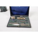 A boxed manicure set with hallmarked silver handles and cover, Birmingham 1918