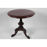 A miniature rosewood circular occasional table on turned column and carved tripod base, 12½" x