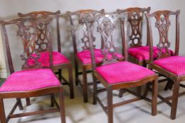 A set of six Chippendale style mahogany chairs with carved rails and pierced and carved splats,