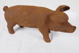 A cast iron garden figurine of a pig, 17" long