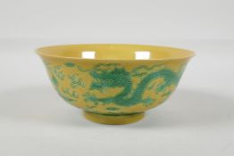 A Chinese yellow ground porcelain rice bowl with incised green enamel dragon decoration, 6 character