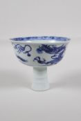 A Chinese black & white porcelain stem cup, decorated with a dragon chasing the flaming pearl, 3½" h