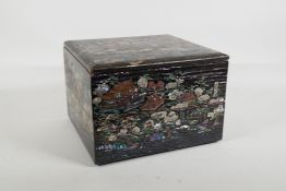 A Japanese Mother of Pearl inlaid black lacquer multi layer box, decorated with views of riverside