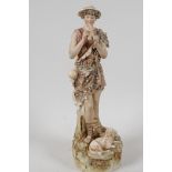 A Royal Dux porcelain figurine of a shepherd boy playing the pan pipes, 12" high