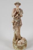 A Royal Dux porcelain figurine of a shepherd boy playing the pan pipes, 12" high