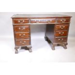 An Edwardian mahogany nine drawer pedestal desk, with swan neck handles and moulded front drawers,