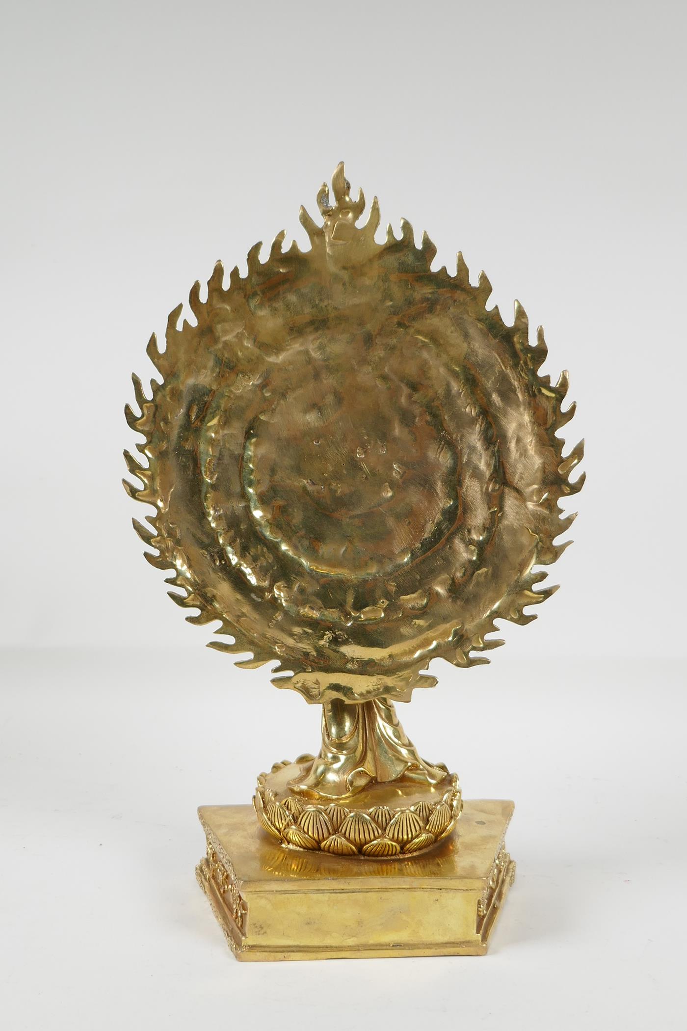 A Sino-Tibetan gilt bronze of a deity with many arms, on a lotus flower, 12½" high - Image 4 of 5