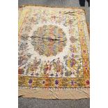 A large Indian silk woven bedspread, decorated with processional and tiger hunting scenes, around