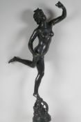 A bronze figurine of a female nude standing on a wheel, 22½" high, lacks plinth