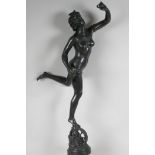 A bronze figurine of a female nude standing on a wheel, 22½" high, lacks plinth