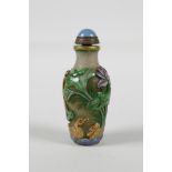 A Peking glass snuff bottle with carved & enamelled decoration of toads & waterfowl in a lotus pond,