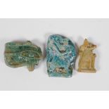 An Egyptian Faience pottery token, in the form of the Eye of Ra, together with two other similar