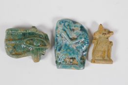 An Egyptian Faience pottery token, in the form of the Eye of Ra, together with two other similar